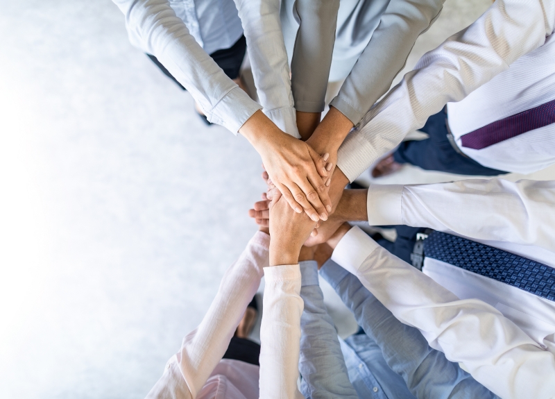 Diverse set of hands together.