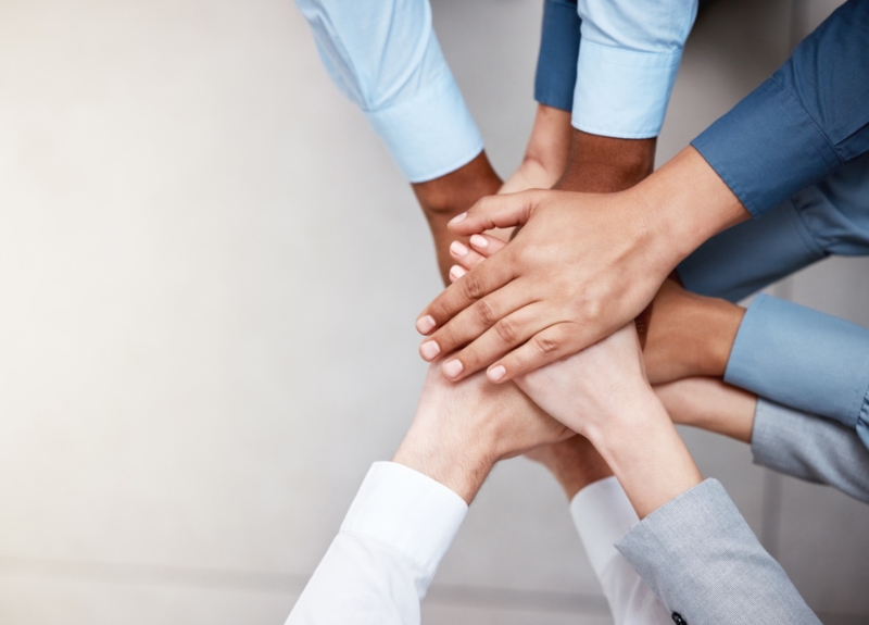 Diverse set of hands together.