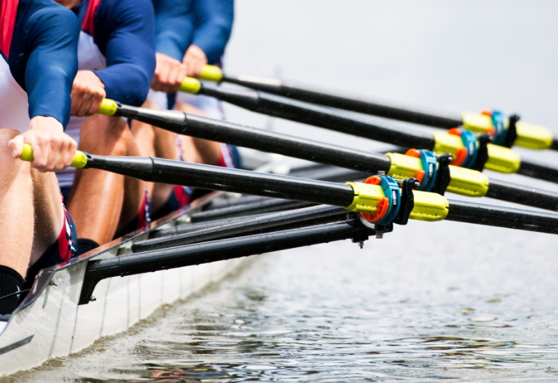 Four people rowing a boat.